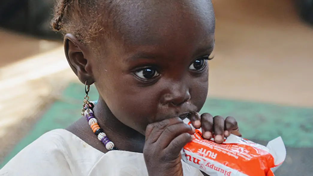 Toddler eating a bar